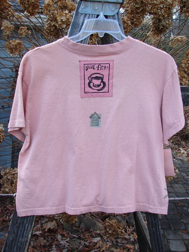 1994 NWT Short Sleeved Tee Garden Critter Seashell Size 3, featuring a thick ribbed neckline, slight bottom flare, and a signature Blue Fish poetry patch, captured in a full front view.