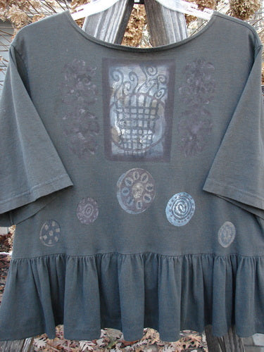 Image alt text: "1992 Holiday Short Sleeved Peplum Top: Grey shirt with a patterned design, drop shoulders, and a peplum lower. Made from mid-weight cotton jersey. Size 1."