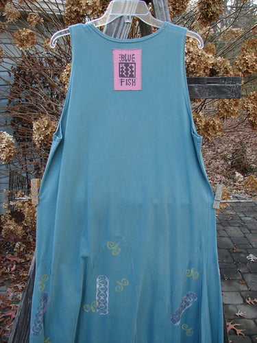 1993 Journey Jumper Vase and Heart Ocean Size 1: A blue dress on a clothesline with lower vertical arches, a belled shape, and a deeper neckline.