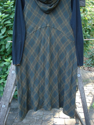 Barclay Rayon Linen Ruffle Pocket Dress in Brown Plaid, featuring a hi-low hemline, ribbed sleeves, and lace accents, showcasing a unique blend of vintage style and modern design.