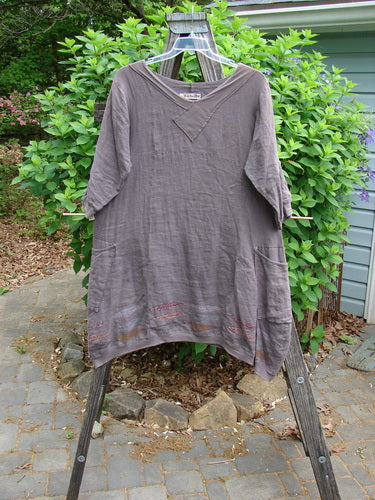 Barclay Linen Crossover Urchin Dress Feather Border Pebble Size 0 features a V-neckline, drop shoulders, empire waist, asymmetric hem, flutter lining, and double side pockets, embodying Blue Fish Clothing's vintage charm.