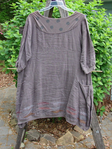 Barclay Linen Crossover Urchin Dress Feather Border Pebble Size 0, featuring a crossover V-neck, drop shoulders, and a curved empire waist, with flutter hemline and double pockets, ideal for summer wear.