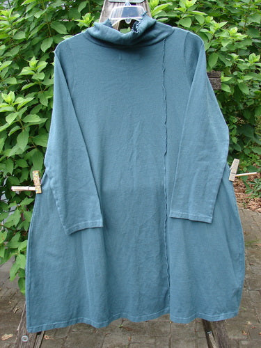 Barclay NWT Eco Cotton Cowl Pocket Tunic Star Moon Hypnea Teal Size 0 displayed on a clothesline, emphasizing its unique cowl neck and practical pocket design, capturing the creative essence of Bluefishfinder.com.