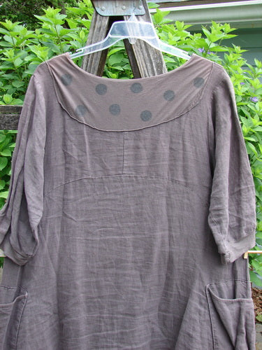 Barclay Linen Crossover Urchin Dress Feather Border Pebble Size 0 features a V-neck crossover front, drop shoulders, double pockets, and a flutter hemline, embodying vintage Blue Fish Clothing's creative individuality.