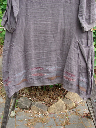 Barclay Linen Crossover Urchin Dress Feather Border Pebble Size 0, featuring a crossover V-neck, drop shoulders, empire waist seam, flutter hemline, and double pockets, epitomizing BlueFishFinder's vintage, creative style.