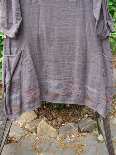 Barclay Linen Crossover Urchin Dress Feather Border Pebble Size 0, featuring a crossover V-neck, drop shoulders, empire waist seam, flutter hemline, and double pockets, epitomizing BlueFishFinder's vintage, creative style.