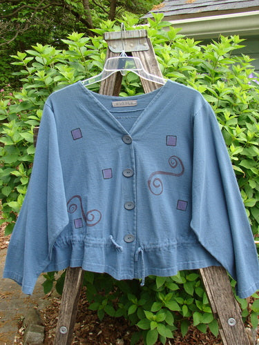 The 1997 Treehouse Jacket Path Less Traveled Blueprint Size 2 showcases a double-paneled V-neck, unique hemline, and draw cord flounce. Features Blue Fish buttons and signature back patch.