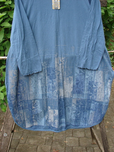 Barclay NWT Natalia Round Bottom Tunic City Floral Echo Blue Size 0, featuring a detailed floral pattern, displayed draped over a fence, showcasing its casual, artistic design signature to BlueFishFinder.com.