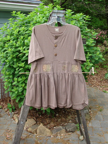 1999 Garden Herb Dress Riverbed Floral Altered Size 1, featuring a slimmer lower flounce, four-paneled pocket, drop waistline, ceramic top button, and flirty hemline, showcasing Bluefishfinder's vintage style and individuality.