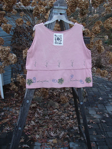 1993 Parallel Top Twig Ash Pink OSFA displayed on a wooden easel, featuring a crop A-line cut, wide rounded neckline, double-layered bodice, and unique twig-themed design.