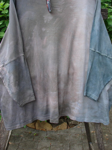 Barclay NWT Patched Supima Taos Mountain Tunic on a rack, showcasing its unique design and detailed patchwork, embodying BlueFishFinder.com's ethos of creative freedom and individuality.