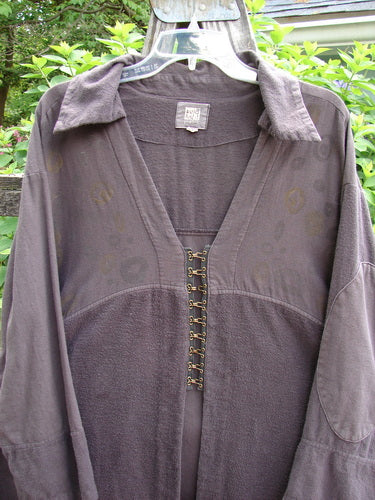 The 2000 Fanne Shirt Bubble Brum Size 1 showcases a unique flannel and canvas pattern with hook-and-eye closures, a deep V-neck, elbow accents, and a flannel-style collar.