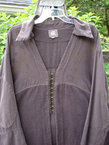The 2000 Fanne Shirt Bubble Brum Size 1 showcases a unique flannel and canvas pattern with hook-and-eye closures, a deep V-neck, elbow accents, and a flannel-style collar.
