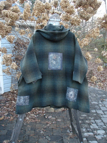 1995 Patched Hooded Autumn Jacket in Cottage Green Plaid, featuring oversized vintage buttons, a cozy double-lined hood, and deep side pockets. A true winter treasure with a blanket-like drape.