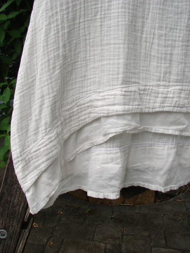 Barclay NWT Gauze Hi Low Batiste Flutter Dress in Unpainted Jasmine Dew, Size 0, showcased with delicate textile detailing, highlighting its elegant flow and craftsmanship, reflecting Bluefishfinder.com's unique vintage style.