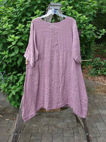 The Barclay NWT Linen Wave Urchin Dress Circle Garden Tulsi Rose Size 0 hangs on a clothesline, showcasing its intricate pattern and lightweight fabric, embodying BlueFishFinder's vintage and expressive fashion ethos.