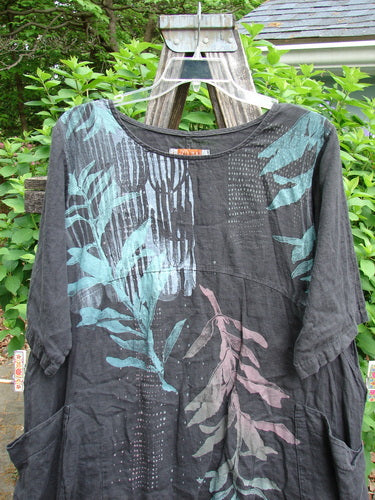 Barclay Linen Two Pocket Urchin Dress Falling Branch Black Size 1 features a rounded neckline, sectional panels, and asymmetrical hem with double front wrap pockets, embodying Bluefishfinder.com's vintage aesthetic.