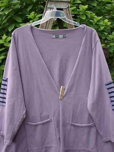 Barclay Sample Open Front Stripe Patch Jacket in Celestial Lavender gracefully draped on a hanger, showcasing its unique design with visible striped patches and open front style, embodying Bluefishfinder.com's vintage aesthetic.