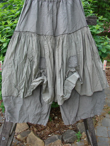 Barclay Linen Batiste Pant Skirt in Grey Green, featuring a full elastic waist, triangular patches with dual ties, and a layered design with tapered sectional panels, embodying Blue Fish's creative freedom.