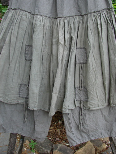 Barclay Linen Batiste Pant Skirt Unpainted Grey Green Size 0, showcasing a full elastic waist, dual ties with triangular patches, and an overpiece layer with double tie accents, embodying creative individuality.