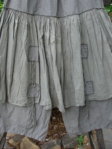 Barclay Linen Batiste Pant Skirt Unpainted Grey Green Size 0, showcasing a full elastic waist, dual ties with triangular patches, and an overpiece layer with double tie accents, embodying creative individuality.