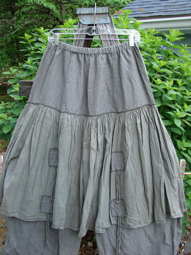 Barclay Linen Batiste Pant Skirt Unpainted Grey Green Size 0 features an elastic waistband, triangular patches, and a double-tie overpiece, showcasing a layered design with tapered pant lowers.