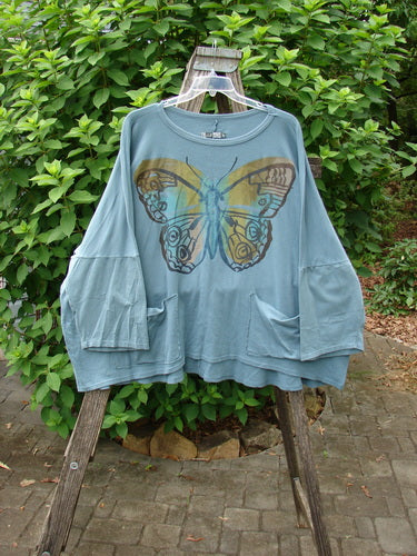 Barclay Two Pocket Mariposa Pullover Blue Sea OSFA featuring a delicate butterfly design, embodying BlueFishFinder.com's vintage charm and creative individuality. Perfect for expressing unique style and personality.