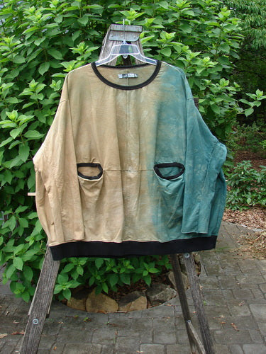 Barclay Cotton Lycra Open Rib Pocket Pullover Mottled Forest Sunset OSFA displayed outdoors on a swinger, showcasing its unique ribbed texture and practical pocket, embodying BlueFishFinder's vintage and expressive style.