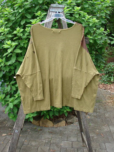 Barclay Dolman Sleeved Pullover Top Wind & Rain Peapod OSFA displayed on a clothes rack, showcasing its elegant long sleeves and flowing fabric, embodying Bluefishfinder.com's vintage and expressive fashion ethos.