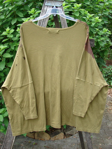 Barclay Dolman Sleeved Pullover Top Wind & Rain Peapod OSFA displayed on a clothes rack, showcasing the relaxed fit and intricate fashion design pattern, embodying Bluefishfinder.com's vintage, expressive style.