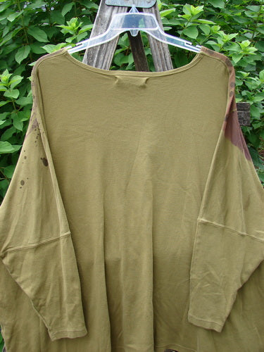 Barclay Dolman Sleeved Pullover Top Wind & Rain Peapod OSFA displayed on a swing, showcasing its unique texture and versatile design, reflecting Bluefishfinder.com's vintage, expressive clothing ethos.