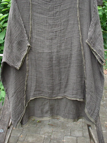 The Barclay Gauze Linen Exterior Curve Hi Low Pullover Unpainted Stick OSFA is displayed elegantly on a rack, capturing the essence of vintage Blue Fish Clothing's unique, free-spirited style.