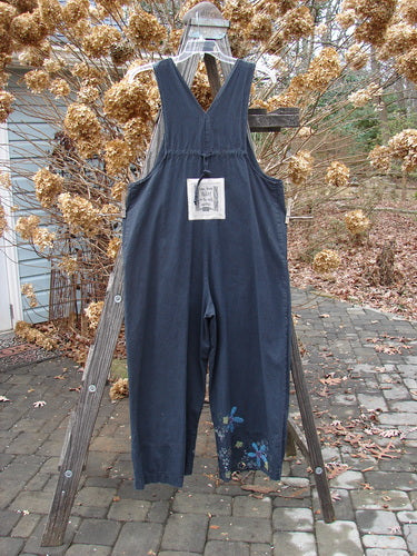 2000 Parachute Overall Jumper Floral Black Size 0: A blue overall with oversized front bib pocket, deep side pockets, adjustable shoulder straps, and wide swingy lowers.