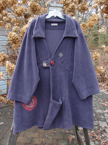 Barclay Celtic Moss Patched Highlander Coat featuring oversized vintage buttons, deep collar, and unique seam design, displayed on a hanger.