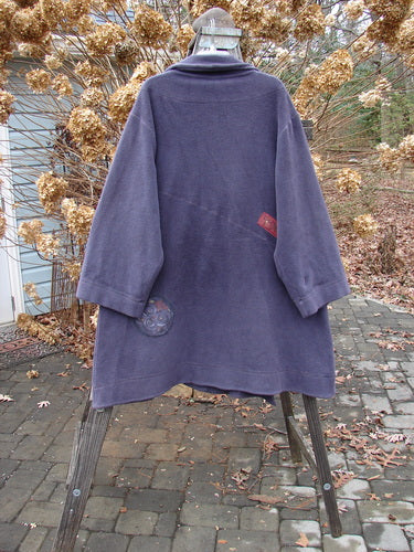 Barclay Celtic Moss Patched Highlander Coat in Deep Violet on a stand, showcasing its dense fleece texture, diagonal seams, oversized buttons, and unique front pocket.