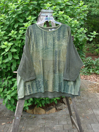 Barclay Modernist High Low Top Continuous Path Black Green Stripe OSFA displayed on a wooden rack, showcasing its unique stripes and high-low design, reflecting Bluefishfinder.com's vintage, creative fashion ethos.