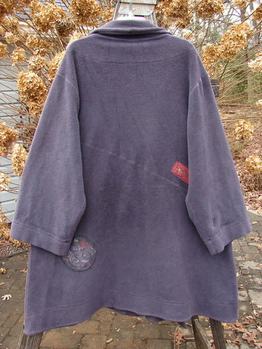 Barclay Celtic Moss Patched Highlander Coat in Deep Violet displayed on a swing hanger, featuring oversized vintage buttons, empire waistline, and dense, wind-resistant fleece with significant patches.
