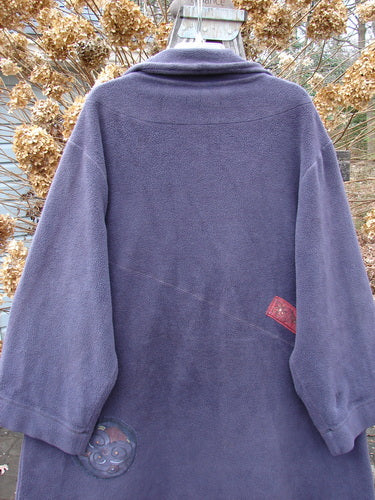 Barclay Celtic Moss Patched Highlander Coat in Deep Violet, Size 1, displayed on a hanger, featuring oversized vintage buttons, diagonal seams, and a significant front lower pocket.