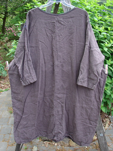 Barclay Linen Oversized Gallery Dress Shop Dress Stick OSFA, featuring a rounded neckline, drop shoulders, three-quarter dolman sleeves, and a wide straight shape, exemplifies BlueFishFinder's celebration of individual expression.