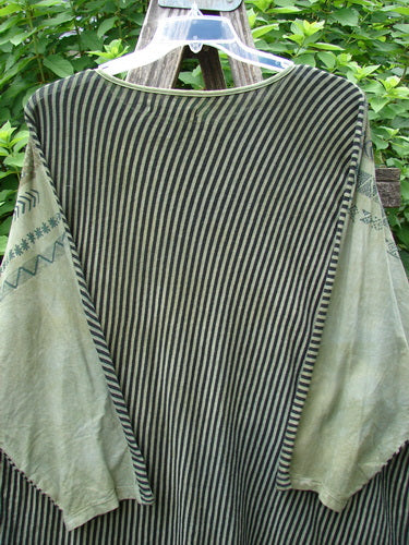 Barclay Modernist High Low Top Continuous Path Black Green Stripe OSFA displayed on a clothes rack, showcasing its unique high-low hem design and striped pattern.