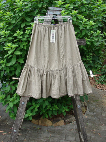 Barclay NWT Batiste Mid Layer Gather Ruffle Skirt Unpainted Dovetail Size 0 displayed on a clothes rack, embodying the vintage, expressive style championed by BlueFishFinder.com through its delicate, gathered ruffle design.