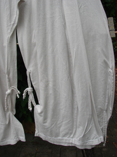 Barclay NWT Crop Billow Pant Unpainted Jasmine Dew Size 0, featuring delicate ties and billowy sleeves, showcased on a clothes hanger, embodying the vintage and creative essence of BlueFishFinder.com.