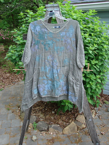 Barclay Linen Two Pocket Urchin Dress Mixed Garden Grey Moss Size 0, features an empire waist, rounded neckline, A-line flair, swaying hem, wider sleeves, and exterior drop front pockets.