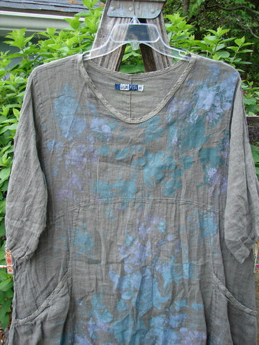 Barclay Linen Two Pocket Urchin Dress in Grey Moss features a rounded neckline, A-line flair, empire waist seam, and mixed garden theme paint, offering a unique vintage style from Bluefishfinder.com.