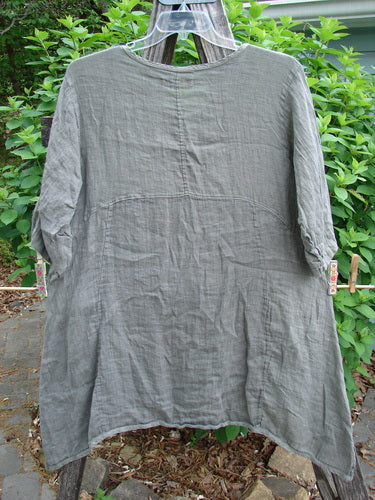 Barclay Linen Two Pocket Urchin Dress Mixed Garden Grey Moss Size 0, featuring a rounded neckline, empire waist seam, swaying hemline, wider sleeves, A-line flair, exterior drop front pockets, and garden-themed design.