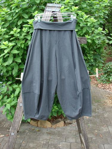 Barclay NWT Cotton Lycra Fold Over Forager Pocket Pant displayed on a wooden ladder, highlighting the unpainted black sand design with distinctive fold-over waistband and practical pockets, embodying BlueFishFinder's vintage spirit.