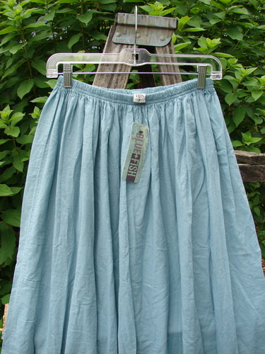 Barclay NWT Batiste Airy Gather Bottom Skirt, featuring unpainted turquoise pinstripes, is elegantly draped on a swinger. This size 0 skirt embodies Bluefishfinder.com's unique vintage fashion ethos.