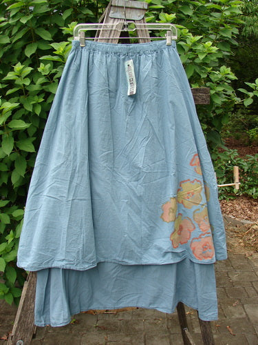 Barclay NWT Batiste Two Tier Layer Skirt Floral Cluster Sea Size 0 features intricate floral patterns. This close-up highlights the delicate textile and wooden slide, embodying Bluefishfinder.com's vintage and expressive fashion aesthetic.