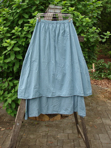 Barclay NWT Batiste Two Tier Layer Skirt Floral Cluster Sea Size 0 displayed on a clothes rack, showcasing its layered design and intricate floral pattern, embodying BlueFishFinder's vintage, expressive style.