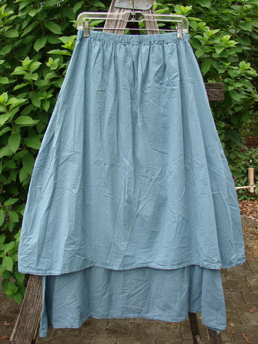 Barclay NWT Batiste Two Tier Layer Skirt Floral Cluster Sea Size 0 displayed on a clothes rack, showcasing its intricate floral pattern and tiered design, reflecting BlueFishFinder.com's vintage, expressive style.